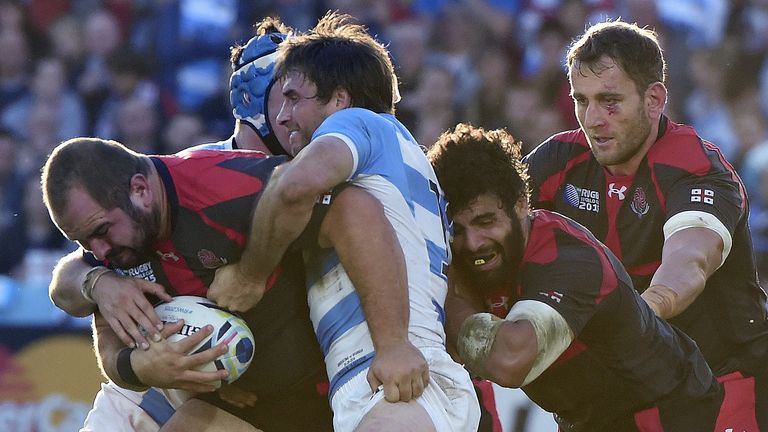 Georgia hooker Jaba Bregvadze (left) is tackled by Argentina duo Matias Alemanno and Marcelo Bosch (middle)