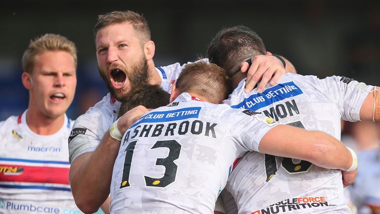  Wakefield's Danny Kirmond celebrates with his team-mates after scoring a try