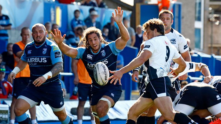 .Zebre's Luke Burgess under pressure from Cardiff Blues' Josh Navidi