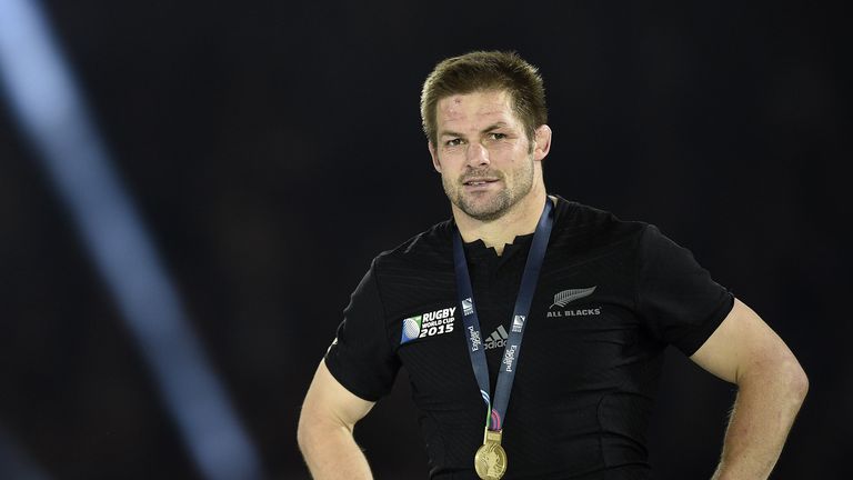 New Zealand's flanker and captain Richie McCaw celebrates with his gold medal after winning  the final match of the 2015 Rugby World Cup