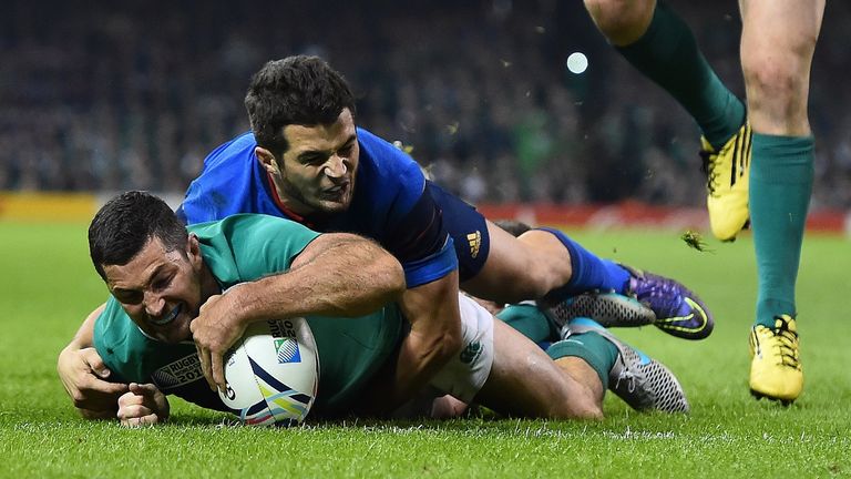 France's wing Brice Dulin (L) attempts to stop Ireland's full-back Rob Kearney score a try during France v Ireland at the Millennium Stadium