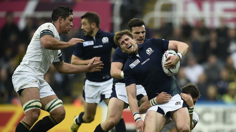 Scotland's centre Matt Scott is tackled by South Africa's fly half Handre Pollard (R)