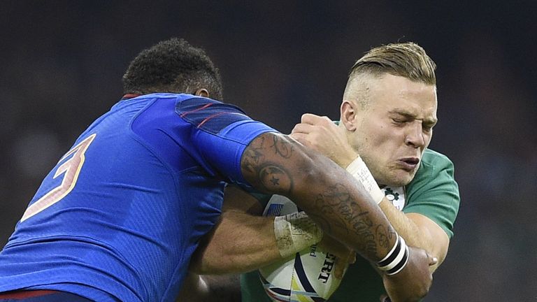Ireland's fly half Ian Madigan (R) is tackled by France's centre Mathieu Bastareaud (L) during the Pool D match between France and Ireland 