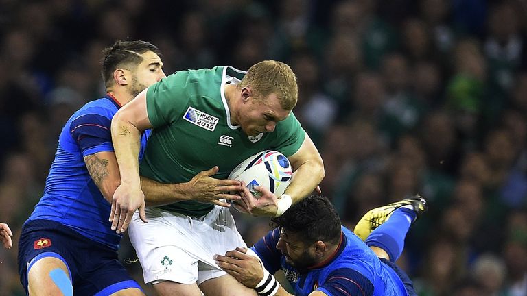 Ireland's centre Keith Earls (C) is tackled by France's flanker Damien Chouly (R) during the Pool D match between France and Ireland