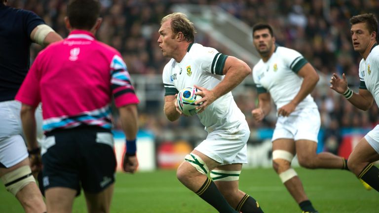 South Africa's flanker Schalk Burger runs at the Scotland defence