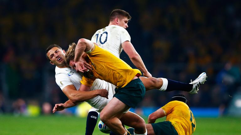 Sam Burgess of England hauls down Michael Hooper of Australia 