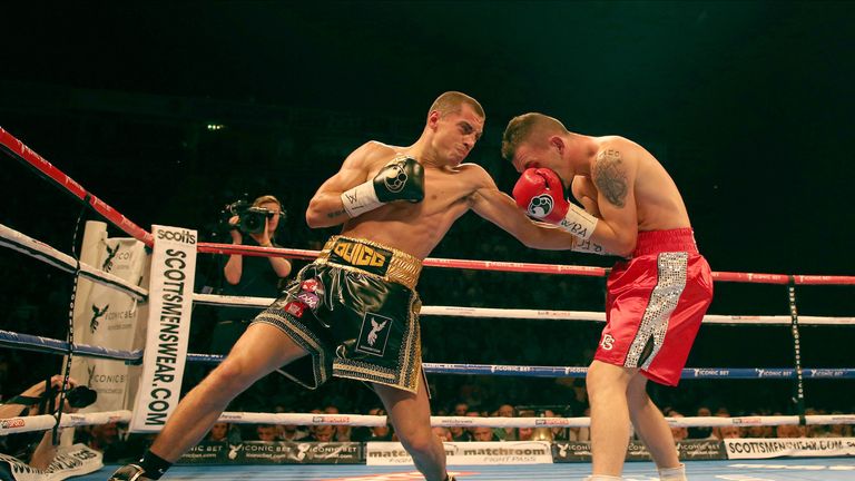 Scott Quigg (L) exchanges blows with Stephane Jamoye during the WBA World Super Bantamweight fight at the Phones 4u Are
