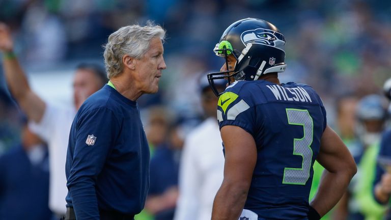 Head coach Pete Carroll of the Seattle Seahawks talks with quarterback Russell Wilson.
