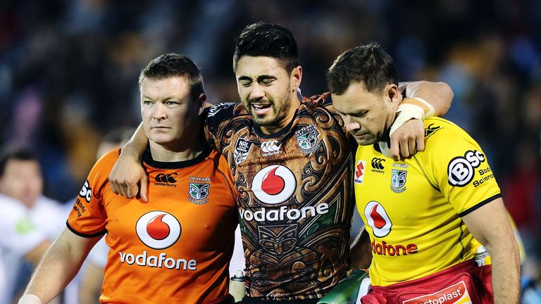 Shaun Johnson of the Warriors is carried off the field after a knock to his leg during the round 20 NRL match