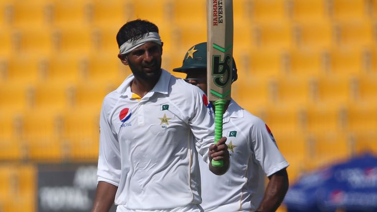Pakistan's Shoaib Malik raises his bat to the crowd as he celebrates his double century