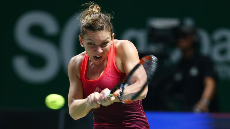 Simona Halep of Romania in action against Maria Sharapova of Russia in a round robin match during the WTA Finals in Singapore