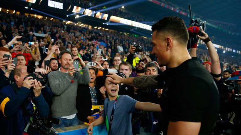  Sonny Bill Williams  gives his winners medal to a young fan