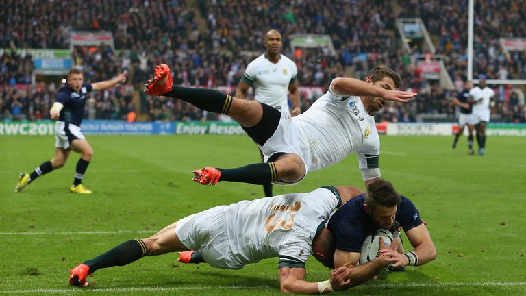 NEWCASTLE UPON TYNE, ENGLAND - OCTOBER 03:  Tommy Seymour of Scotland evades the South Africa tackles as he scores their first try during the 2015 Rugby Wo