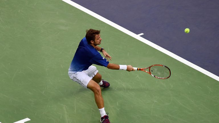 Stanislas Wawrinka of Switzerland hits a return during his men's singles quarter-final match against Rafael Nadal