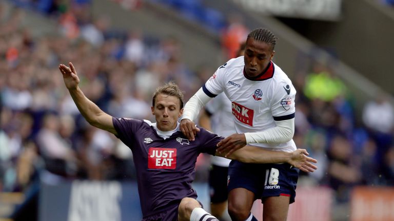 BOLTON, ENGLAND - AUGUST 8:  Neil Danns (R) of Bolton Wanderers and Stephen Warnock of Derby County battle for the ball during the Sky Bet Championship mat
