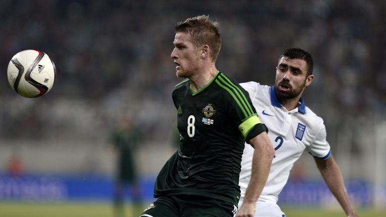 Northern Ireland's midfielder Steven Davis (L) vies with Greece's defender Giannis Maniatis