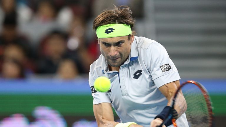 David Ferrer of Spain returns a ball  against Novak Djokovic of Serbia during the Men's single semi-final match
