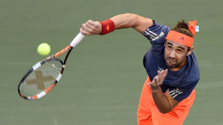 Marcos Baghdatis of Cyprus returns the ball against Benoit Paire of France during their second round match at the Japan Open