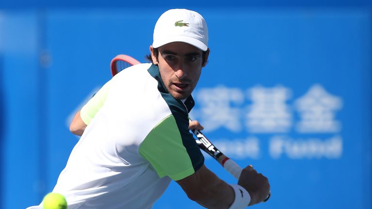 Pablo Cuevas of Uruguay returns a ball against Ivo Karlovic of Croatia during the day six of the 2015 China Open