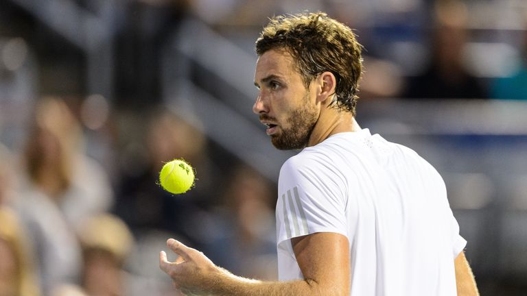 Ernests Gulbis of Latvia prepares to serve against Novak Djokovic of Serbia during day five of the Rogers Cup at Uniprix Stadium