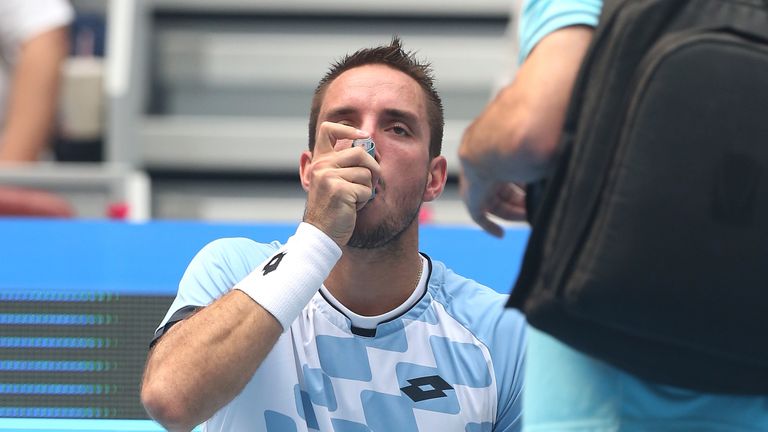 Viktor Troicki of Serbia receives treatment during the match against Yen-Hsun Lu of Taipei