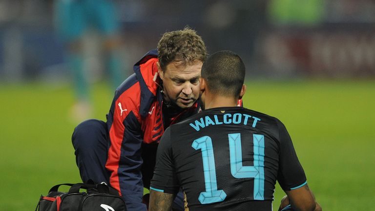 Arsenal's Theo Walcott is treated during the 3-0 defeat to Sheffield Wednesday