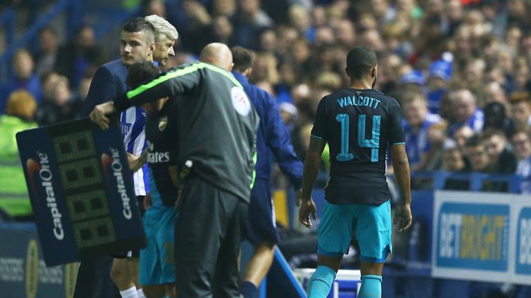 First half substitute Theo Walcott of Arsenal comes off injured