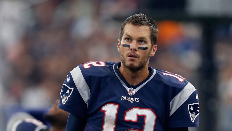Quarterback Tom Brady #12 of the New England Patriots stands on the sideline during the first half of the NFL game against the 