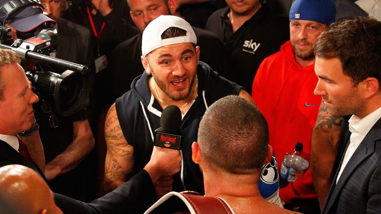 LIVERPOOL, ENGLAND - JULY 12:  Tony Bellew (bottom) of England has words with boxer Nathan Cleverly (C) of Wales 