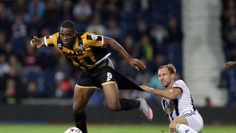 Craig Dawson (R) of West Brom fouls Uche Ikpeazu of Port Vale during the Capital One Cup second-round match