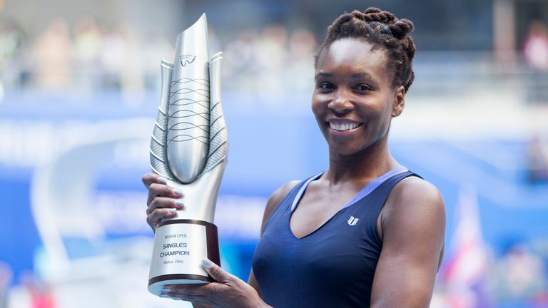 Venus Williams of USA poses with her trophy after winning the women's singles final against Garbine Muguruza 