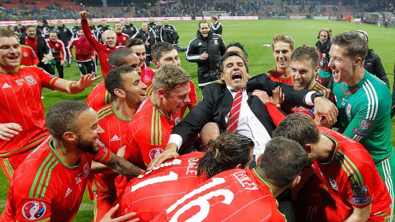 Wales head coach Chris Coleman celebrates with players after qualifying for Euro 2016.