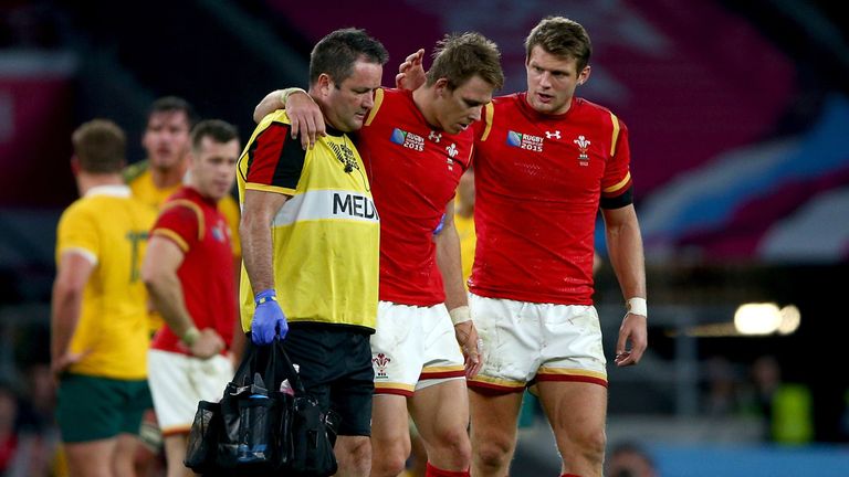   Liam Williams of Wales leaves the field injured consoled by Dan Biggar during the 2015 Rugby World Cup Pool A match 
