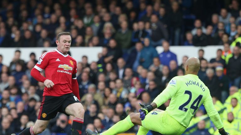 Wayne Rooney of Manchester United in action with Tim Howard of Everton