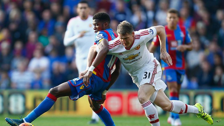 Wilfried Zaha of Crystal Palace and Bastian Schweinsteiger of Manchester United compete for the ball 