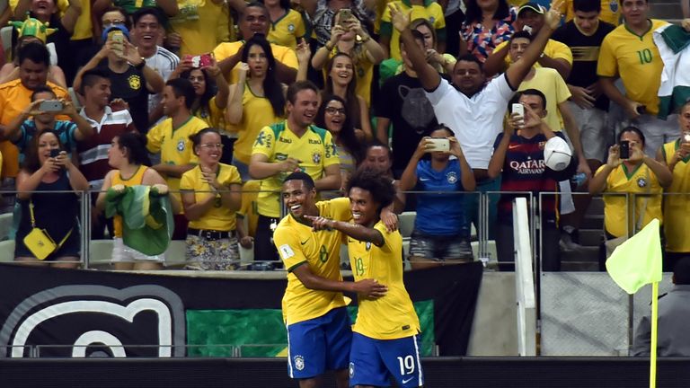Brazil's Willian (R) celebrates with teammate Elias after scoring against Venezuela
