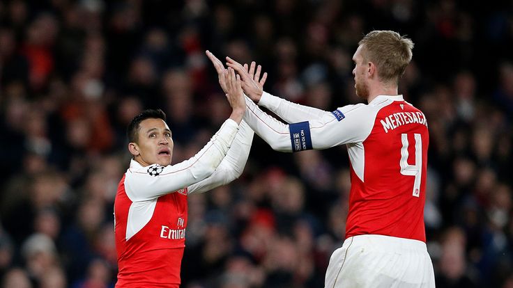 Alexis Sanchez (L) celebrates after scoring Arsenal's third goal during their UEFA Champions League Group F match against Dinamo Zagreb