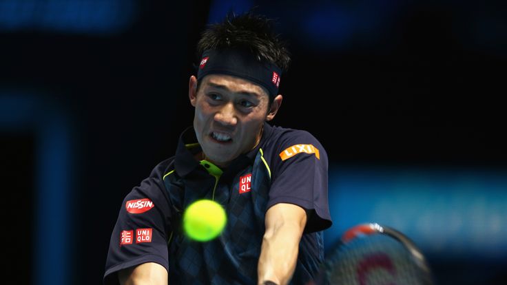 Kei Nishikori of Japan plays a backhand in his men's singles match against Novak Djokovic of Serbia during day one of the Barclays ATP World Tour Finals