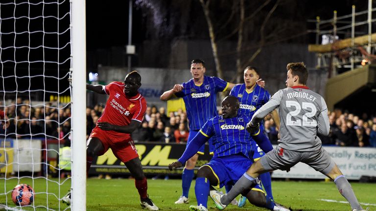 Adebayo Akinfenwa of AFC Wimbledon scores against Liverpool in an FA Cup tie in January 2015