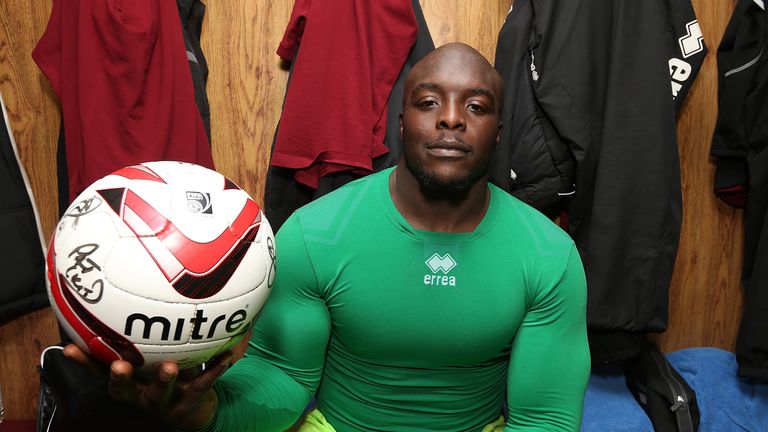 Adebayo Akinfenwa poses with the match ball after scoring the first hat-trick of his career while at Northampton Town
