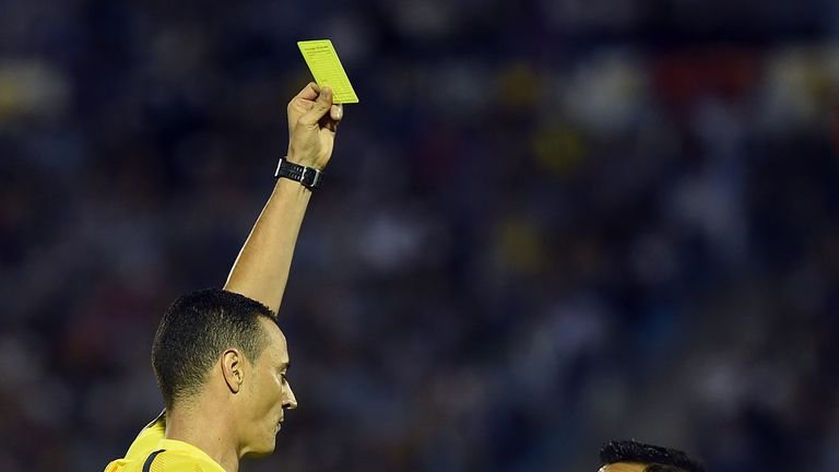 Colombian referee Wilmar Rondan shows a yellow card to Chile's Alexis Sanchez 