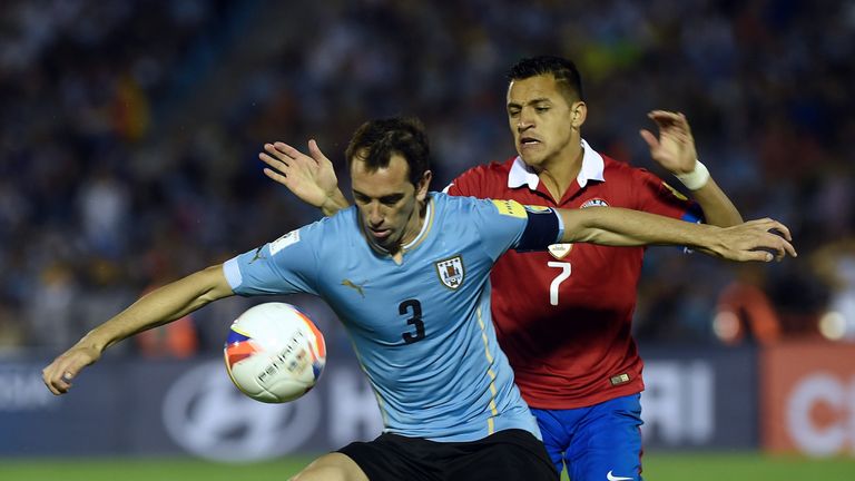 Uruguay's Diego Godin vies for the ball with Chile's Alexis Sanchez