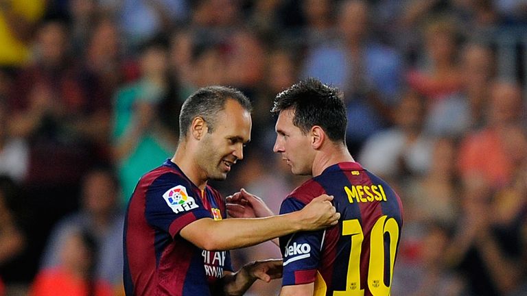 BARCELONA, SPAIN - AUGUST 24: Andres Iniesta of FC Barcelona hands over the captian's armband to Lionel Messi during the La Liga match between FC Barcelona