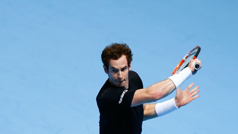 Andy Murray reaches for a backhand in his men's singles match against Rafael Nadal during day four of the Barclays ATP World Tour Finals at the O2 Arena