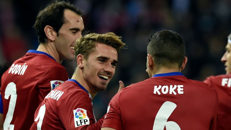 Atletico Madrid's French forward Antoine Griezmann (C) is congratulated by Atletico Madrid's Uruguayan defender Diego Godin
