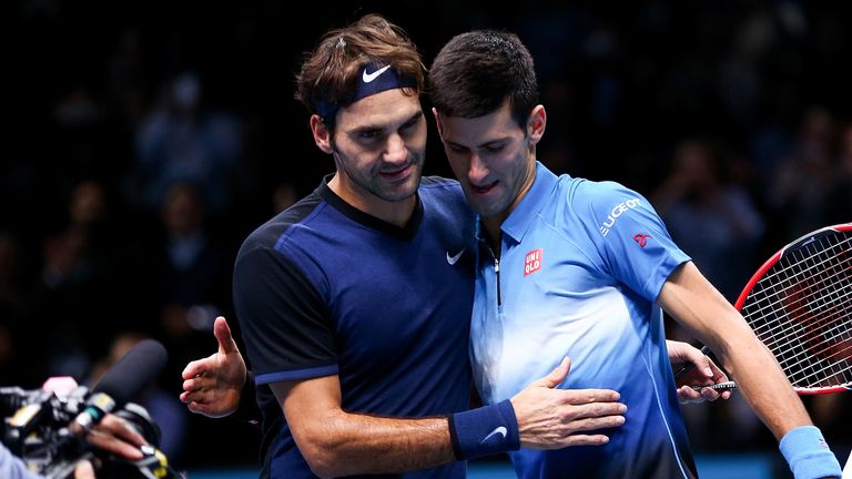 Roger Federer of Switzerland (L) embraces Novak Djokovic of Serbia (R) after his straight sets victory during day three