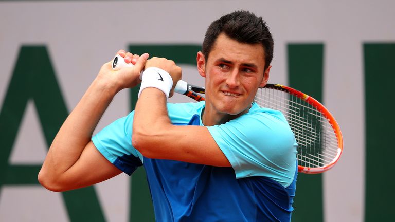 Bernard Tomic of Australia returns a shot during his men's singles match against Richard Gasquet of France on day three of the Fre