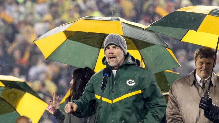 Brett Favre speaks during the retirement ceremony for his #4 jersey at Lambeau Field