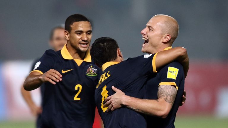 Tim Cahill of Australia celebrates with team-mates Aaron Mooy and James Meredith.