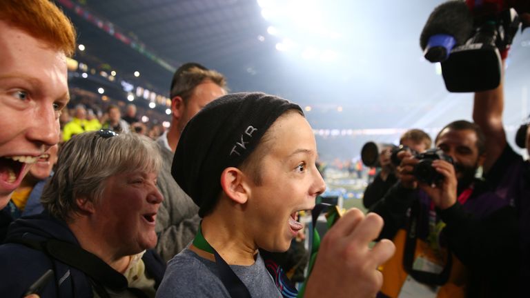 Young fan Charlie Lines reacts to being presented with the winning medal of Sonny Bill Williams of New Zealand